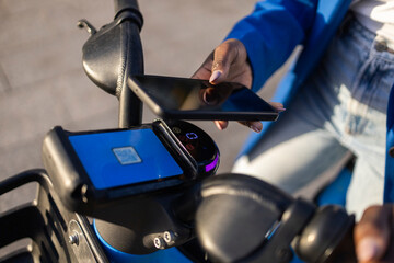 Professional woman using smartphone for e-scooter rental