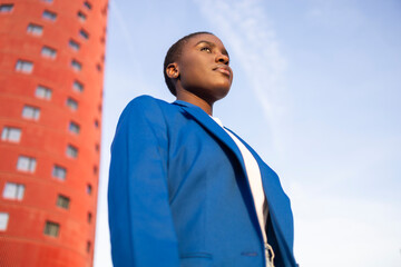 Confident african business woman in blue suit outdoors