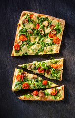 Rechteckige Pizza herausgeschnittene St&uuml;cke Spinat Tomaten Champignons