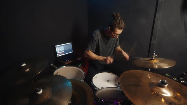 Energetic percussionist performing in small studio setup