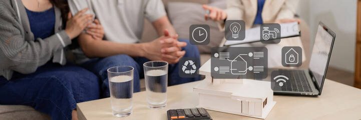 Couple with real estate agent plan new house purchase using smart home technology for modern sustainable living property investment technology automation