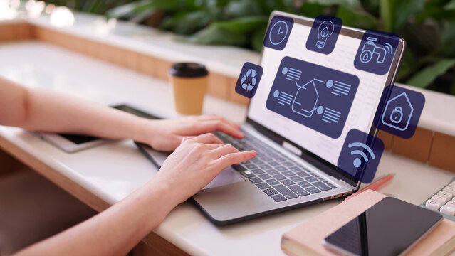 Person using laptop manage smart home application with central control panel for energy efficiency water saving and security automation IoT sustainability technology