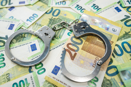 Handcuffs on 100 euro banknotes symbol of corruption and financial crime