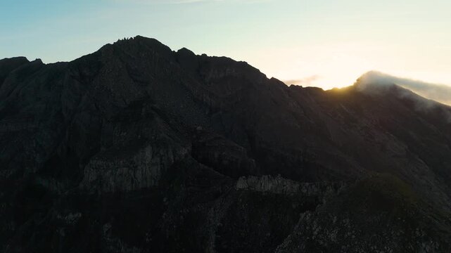4K drone footage of Mount Raung at sunrise, revealing steep ridges, misty forests, and one of Indonesia&rsquo;s most extreme hiking trails with cloud and vulcano 