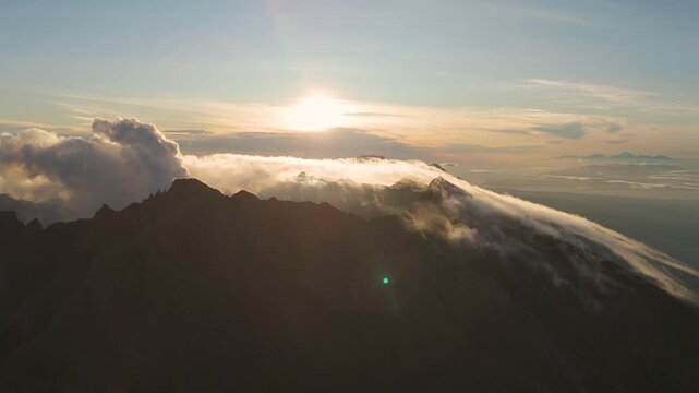 4K drone footage of Mount Raung at sunrise, revealing steep ridges, misty forests, and one of Indonesia&rsquo;s most extreme hiking trails with cloud and vulcano 