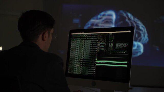 Working on computer with programming codes and a brain image in background