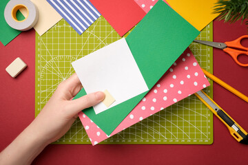 Making a gnome craft. The hands hold three pieces of paper. Creative process.