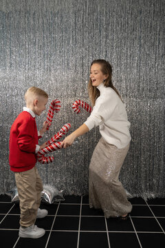 Mother and son holiday fun with candy cane props