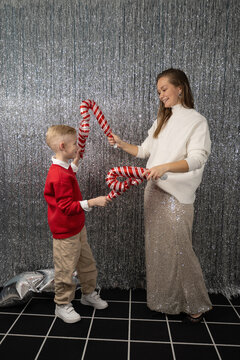 Mother and son celebrating with candy canes