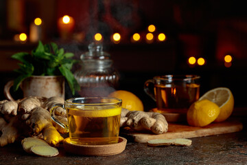 Cup of ginger tea with lemon, honey, mint, and ginger root.