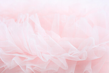 Soft pink background with textured layers of tulle