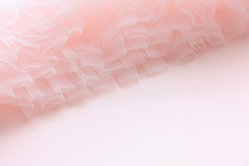 Soft layers of pink tulle backdrop with copy space.