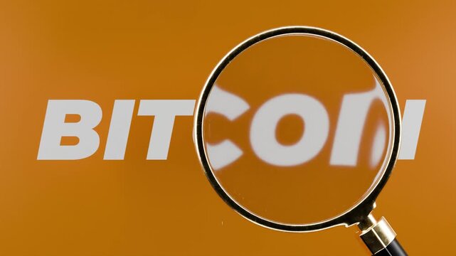 magnifying glass hovering over tex saying bitcoin, cryptocurrency