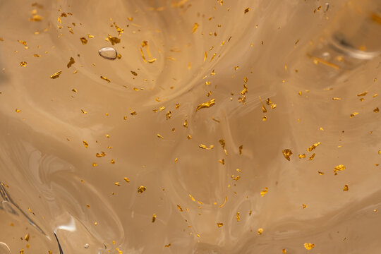Luxurious gel texture with gold flakes for cosmetics
