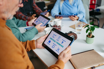 Tutor teaching seniors about phone scams and digital safety.