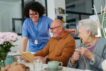Group of senior people enjoying different activities in community center.