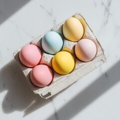 Colorful eggs sit in a carton on a surface with sunlight casting shadows during a festive spring season