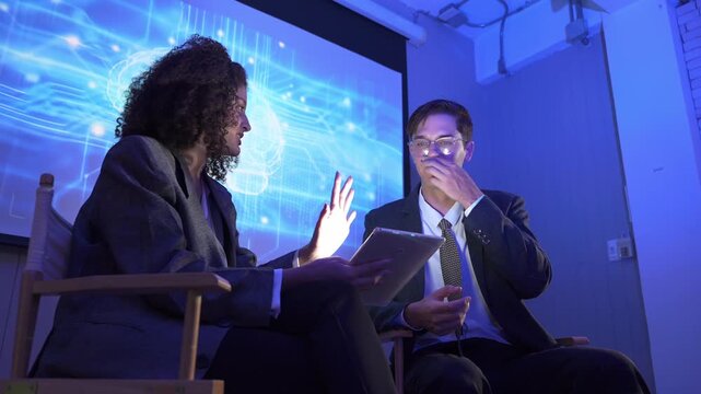 Discussion about brain technology in an office with two people and a digital display