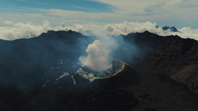 4K drone footage of Mount Raung at sunrise, revealing steep ridges, misty forests, and one of Indonesia&rsquo;s most extreme hiking trails with cloud and vulcano 