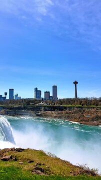 City landscape over Niagara Falls. Skylon Tower in the scenery. View on the majestic landmark from American side. Vertical video.