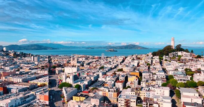 Amazing city scenery of San Francisco, California, United States. View on Coit Tower at the Telegraph Hill. Beautiful blue bay waterscape at backdrop.