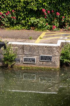 Plaques marking flood heights in 1894, 1947 & 2003 on Osney Lock on the River Thames at Osney, Oxford, England UK