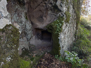 Prehistoric nuraghe stone structure rising from green landscape under dramatic sky in Sardinia