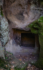 Prehistoric nuraghe stone structure rising from green landscape under dramatic sky in Sardinia