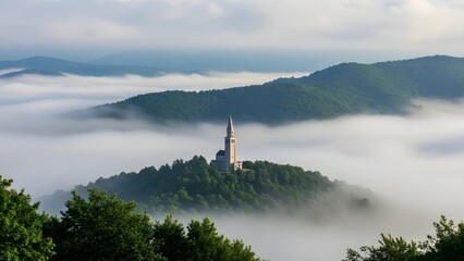 Hilltop church tower rising above dense clouds and forested mountains at dawn with misty atmosphere