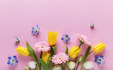 Beautiful banner with spring flowers on pastel pink table top view. Greeting card for International...