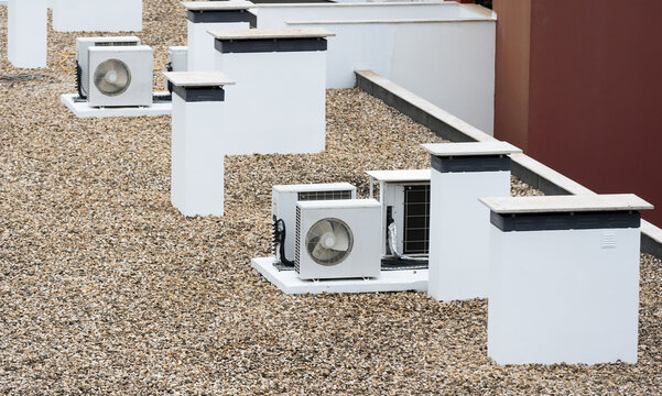 Air conditioning (HVAC) installed on the roof of buildings.