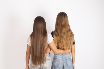 Back view of two young women walking away