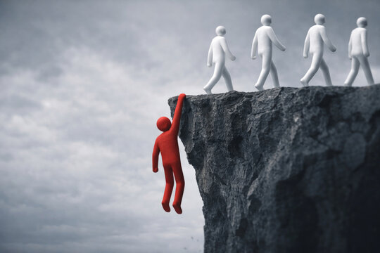 The figure of a man hangs on the edge of a dangerous cliff. Space for text.