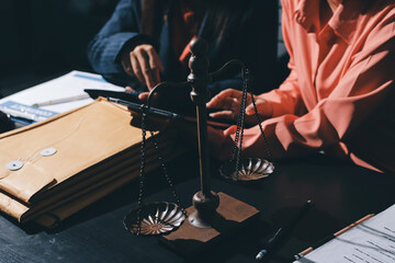 Consultation and conference of professional businesswoman and Male lawyers working and discussion having at law firm in office. Concepts of law, Judge gavel with scales of justice