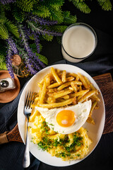 Fried eggs with boiled potatoes and yellow string beans.