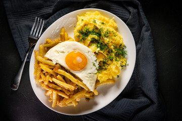 Fried eggs with boiled potatoes and yellow string beans.