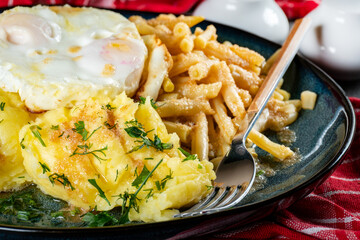 Fried eggs with boiled potatoes and yellow string beans.