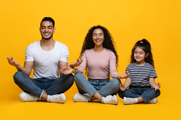 Happy Arab Family Of Three With Little Daughter Meditating Together In Studio, Smiling Middle...