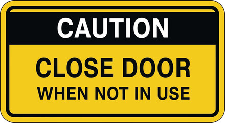 Fototapeta premium Essential yellow and black caution sign clearly indicating the need to close doors when unoccupied, enhancing safety and security in various settings