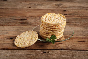 Corn Pancakes Stacked on a Glass Plate on a Wooden Table