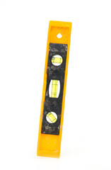 Yellow spirit level tool isolated on white background, used for precise alignment and construction measurement.