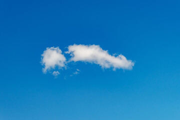 Clean blue sky with isolated cloud creating calm abstract nature scene