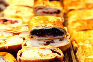 Original homemade strudel. Pile of traditional strudels from Hungary. Hungarian strudel aka r&eacute;tes on market stall
