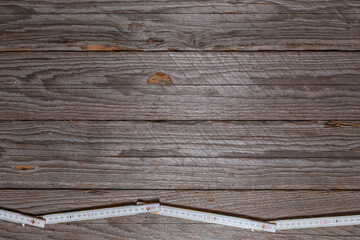 Folded Measuring Stick on Weathered Wood Background Top View with space for text or design
