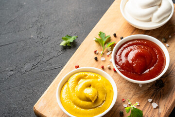 Ketchup, mayonnaise and mustard in the bowls