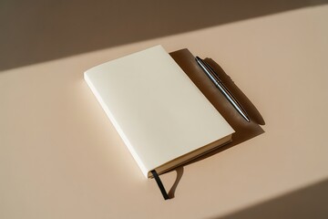 Modern workspace essentials with blank notebook and pen