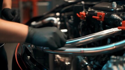 Closeup of custom stainless steel brake lines being installed on a vehicle highlighting precision craftsmanship and tailored fit for enhanced braking control