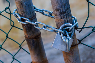 Rusty Gate Chain And Padlock Securing A Chain-Link Fence For Security