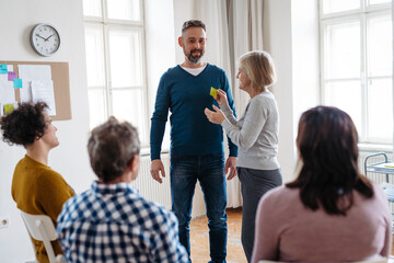 Fototapeta premium Participants labeling feelings during therapeutic workshop.
