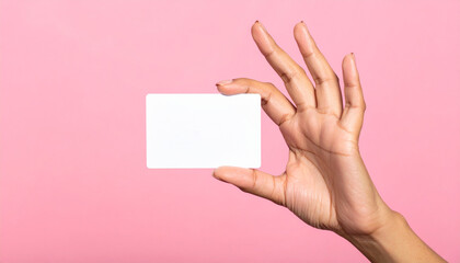 Obraz premium A woman's hand holding a blank white card. For advertising and promotional purposes.